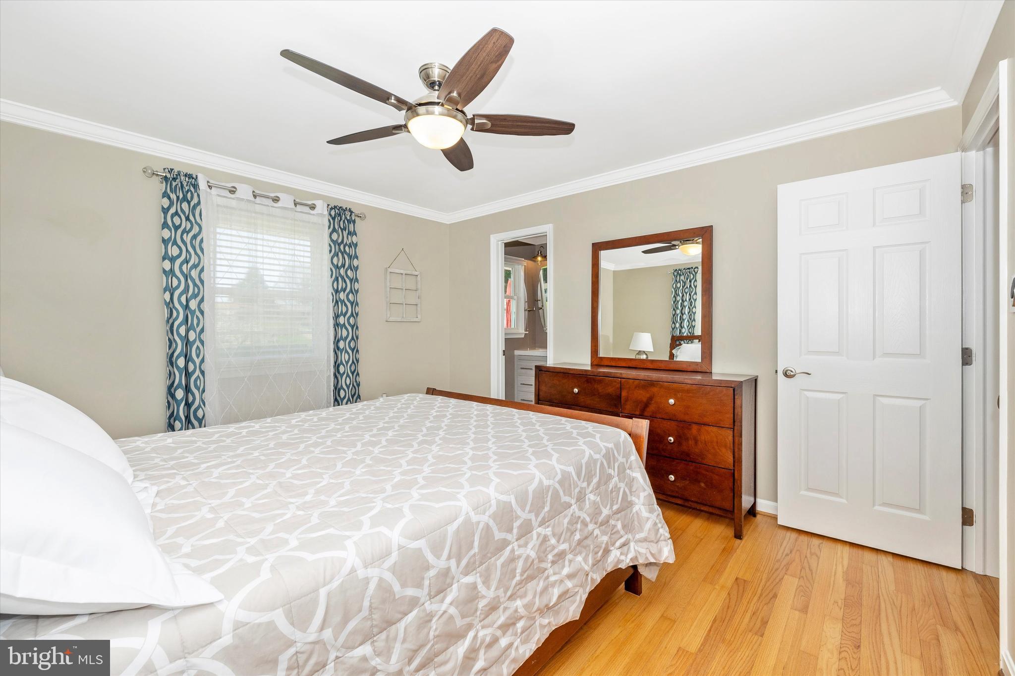 8107 Broadview Drive Frederick, MD 21701 - Photo 22 of 54 a bedroom with a bed and a chandelier