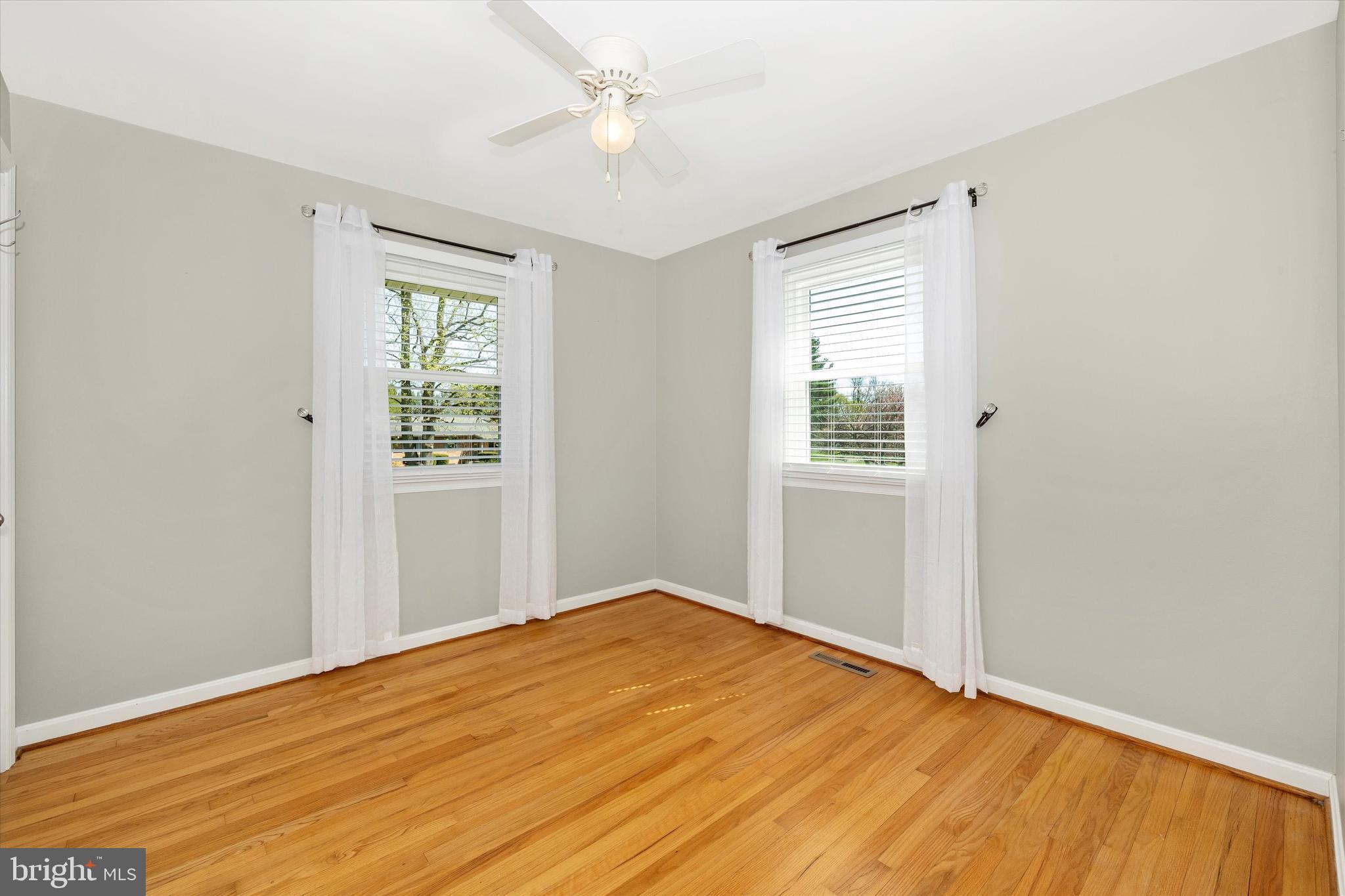 8107 Broadview Drive Frederick, MD 21701 - Photo 29 of 54 a view of empty room with wooden floor and fan