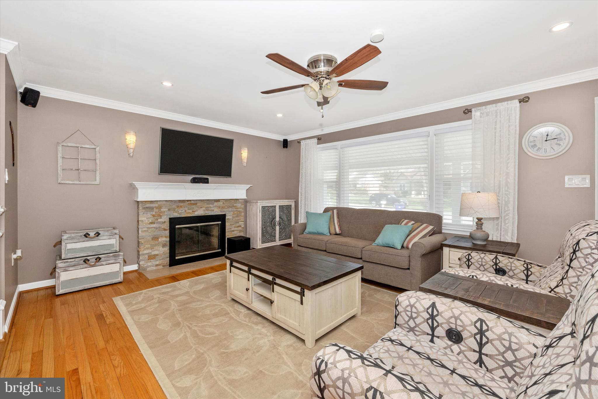 8107 Broadview Drive Frederick, MD 21701 - Photo 6 of 54 a living room with furniture a flat screen tv and a fireplace