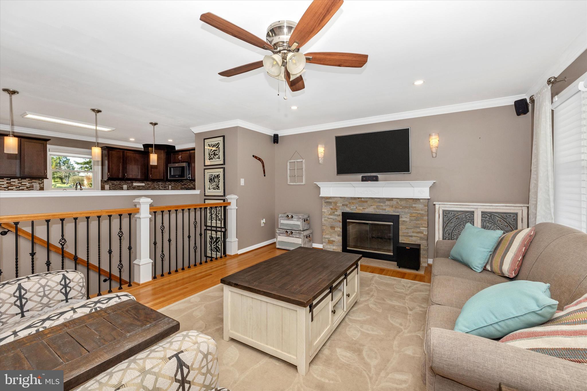 8107 Broadview Drive Frederick, MD 21701 - Photo 7 of 54 a living room with furniture a flat screen tv and a fireplace