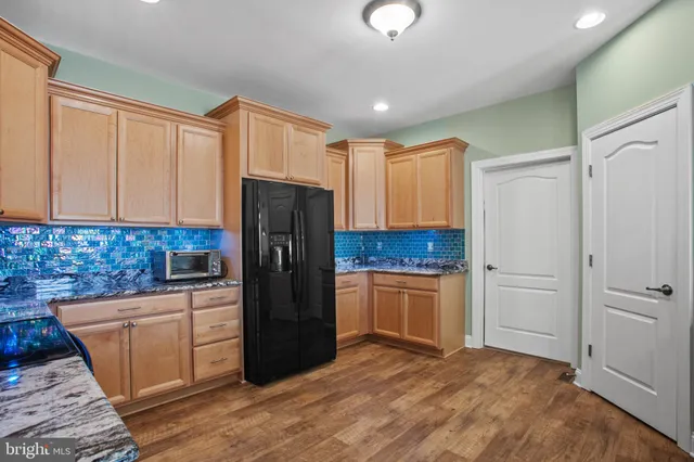 a kitchen with a refrigerator sink and cabinets