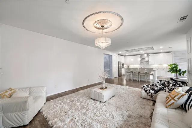 a kitchen with stainless steel appliances kitchen island granite countertop a large stove a sink dishwasher and a refrigerator with wooden floor