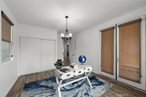 a living room with patio furniture and a floor to ceiling window