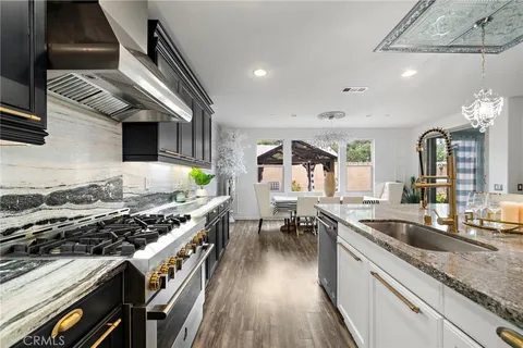 a view of swimming pool with outdoor seating and house in the background