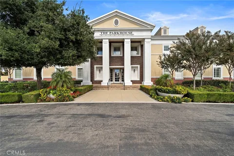 a living room with fireplace furniture and a large window