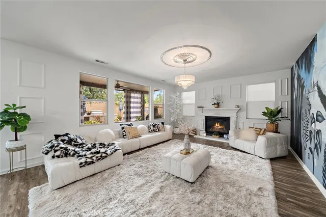 a dining room with furniture potted plants and wooden floor