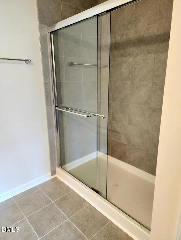 237 Truss Bridge Street Fuquay-Varina, NC 27526 - Photo 11 of 20 a bathroom with a glass shower door
