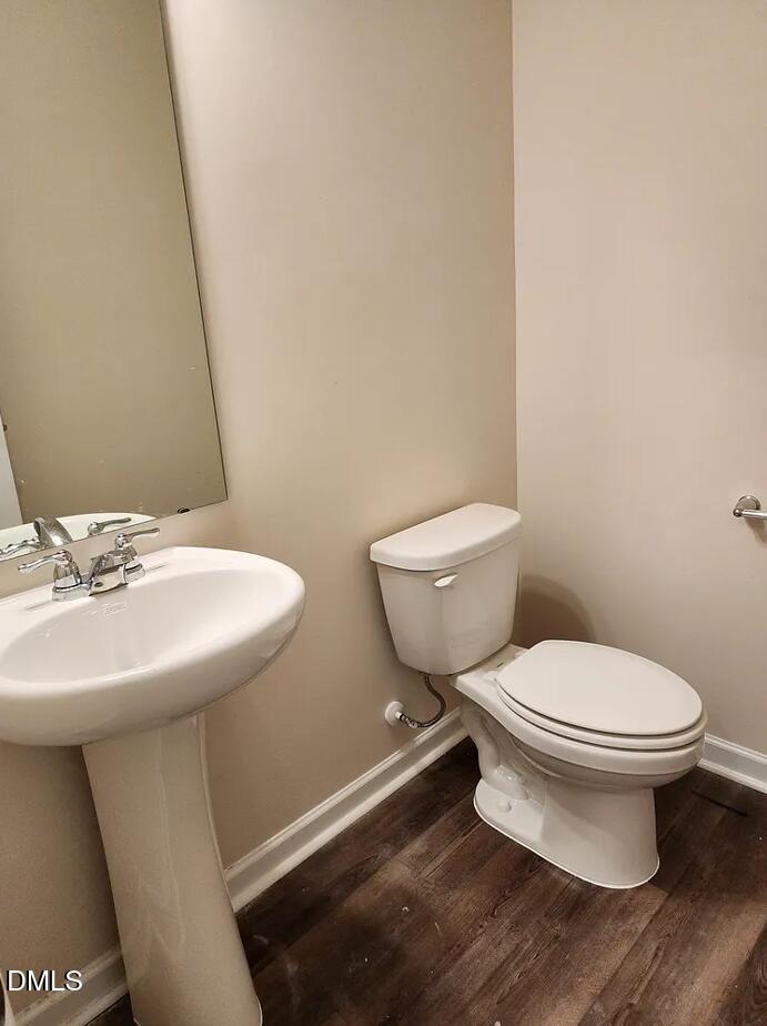 237 Truss Bridge Street Fuquay-Varina, NC 27526 - Photo 12 of 20 a bathroom with a toilet sink and mirror