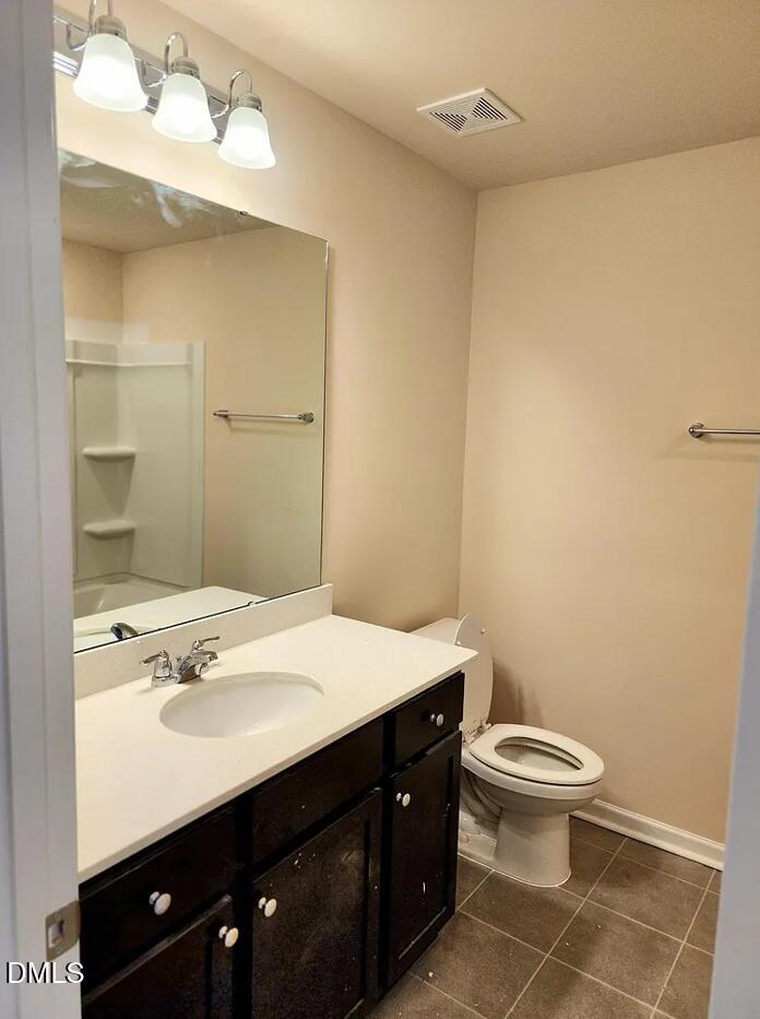 237 Truss Bridge Street Fuquay-Varina, NC 27526 - Photo 19 of 20 a bathroom with a sink a toilet and a mirror