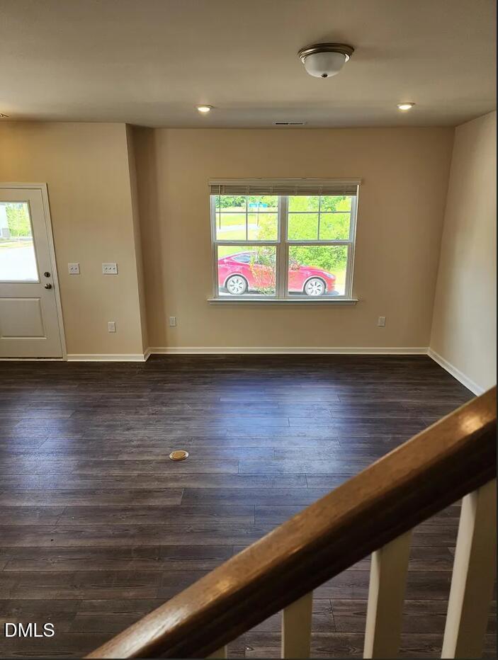 237 Truss Bridge Street Fuquay-Varina, NC 27526 - Photo 7 of 20 an empty room with wooden floor and windows