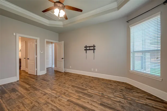 a spacious bathroom with a tub double sink and mirror