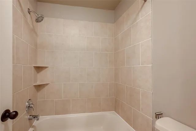 a bathroom with a sink double vanity granite tub shower and a mirror