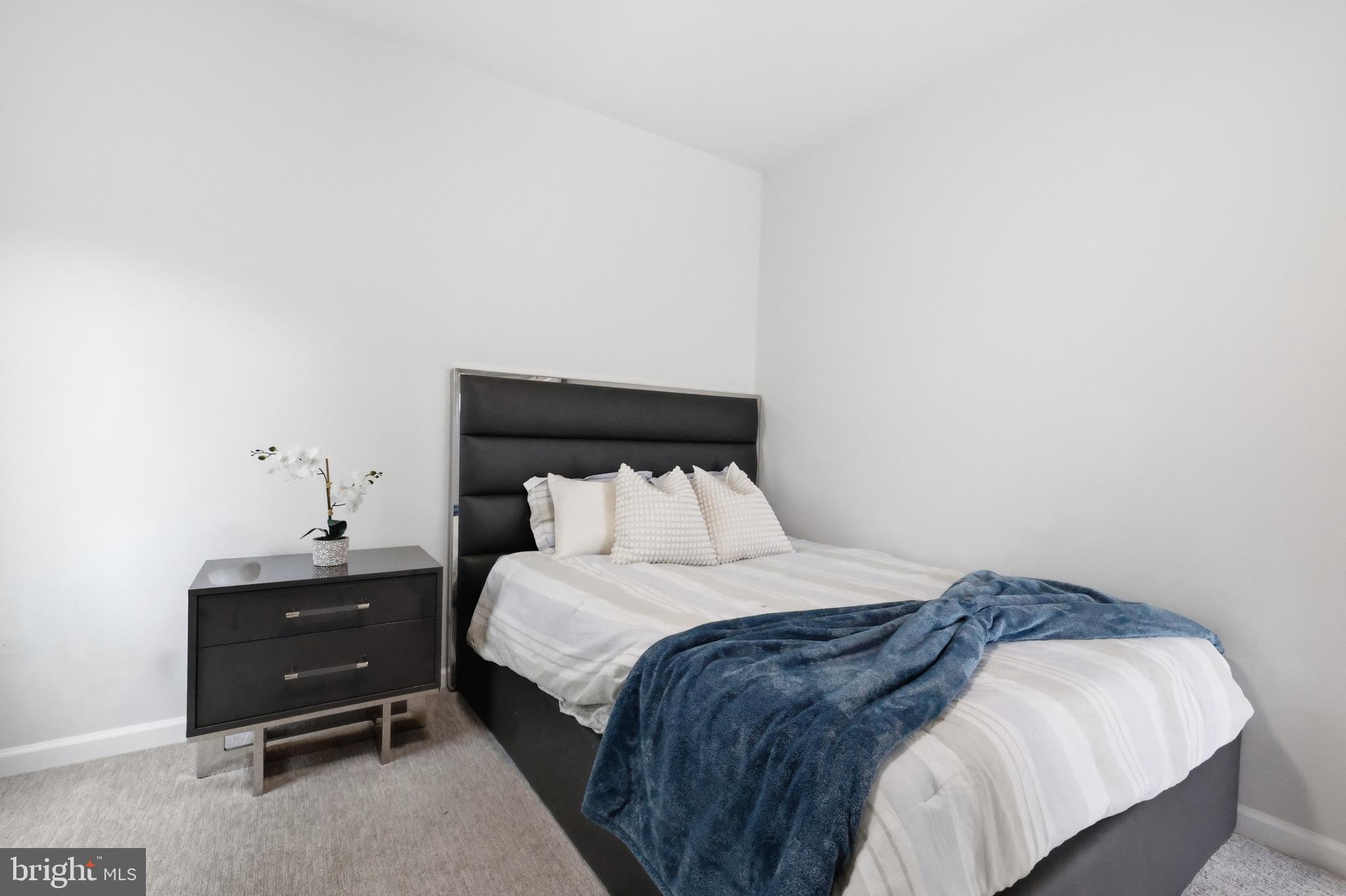 5707 Hawk Ridge Road Frederick, MD 21704 - Photo 31 of 109 a bedroom with a bed and a night stand