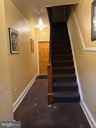 a view of a porch with wooden floor and iron stairs