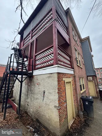 a view of a brick house with many windows