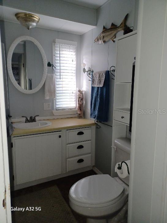 1286 Southwest Tropical Terrace Stuart, FL 34997 - Photo 20 of 28 a bathroom with a toilet a sink and mirror