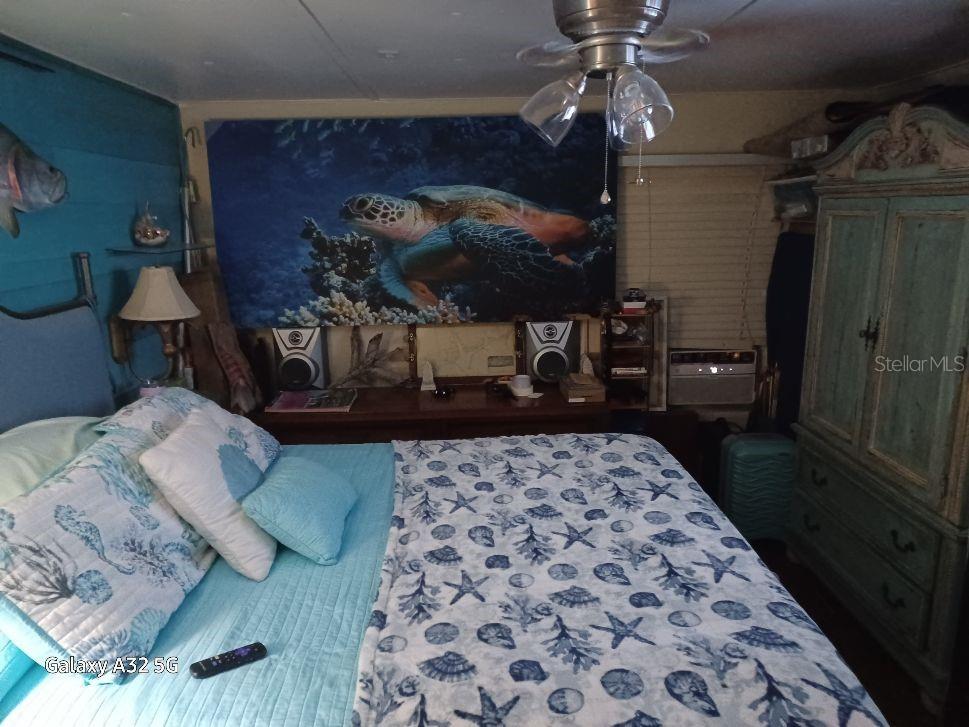 1286 Southwest Tropical Terrace Stuart, FL 34997 - Photo 23 of 28 a bedroom with a bed and a lamp on table