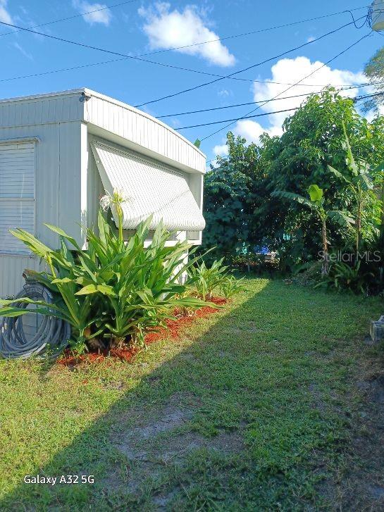 1286 Southwest Tropical Terrace Stuart, FL 34997 - Photo 6 of 28 a view of a yard in front of a house