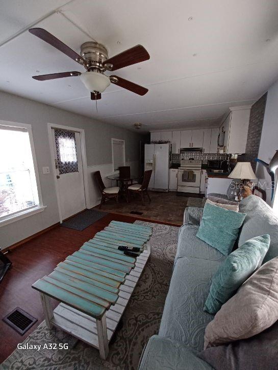 1286 Southwest Tropical Terrace Stuart, FL 34997 - Photo 9 of 28 a living room with furniture and wooden floor