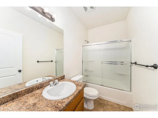 a bathroom with a sink toilet a mirror and shower