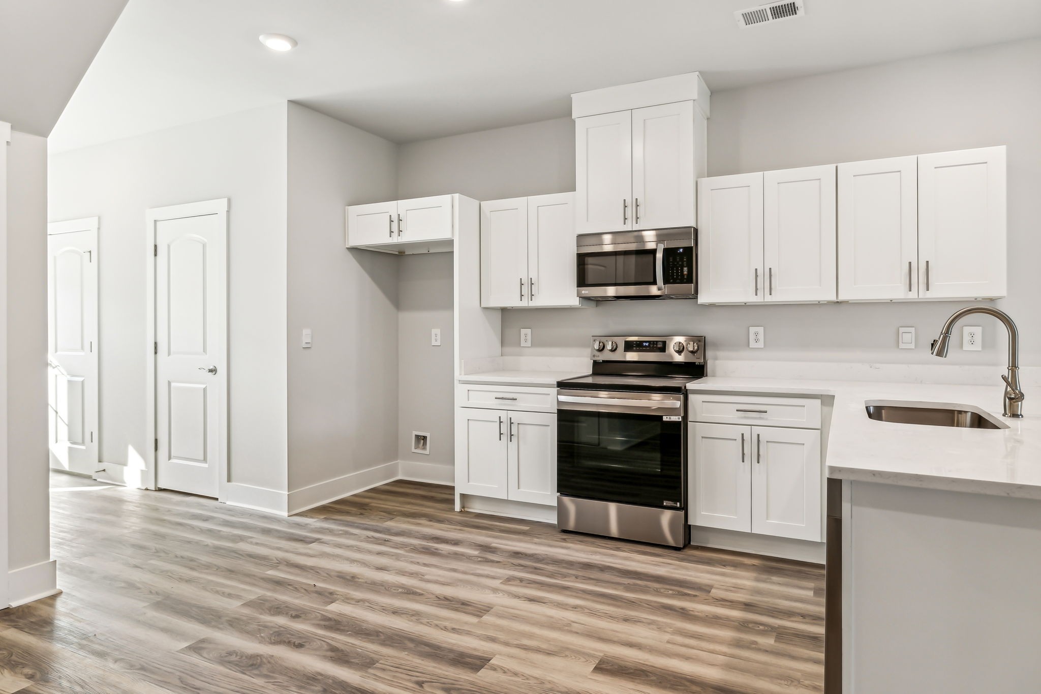 539 Tulip Springs Road Hermitage, TN 37076 - Photo 13 of 69 a kitchen with stainless steel appliances a stove a sink and white cabinets