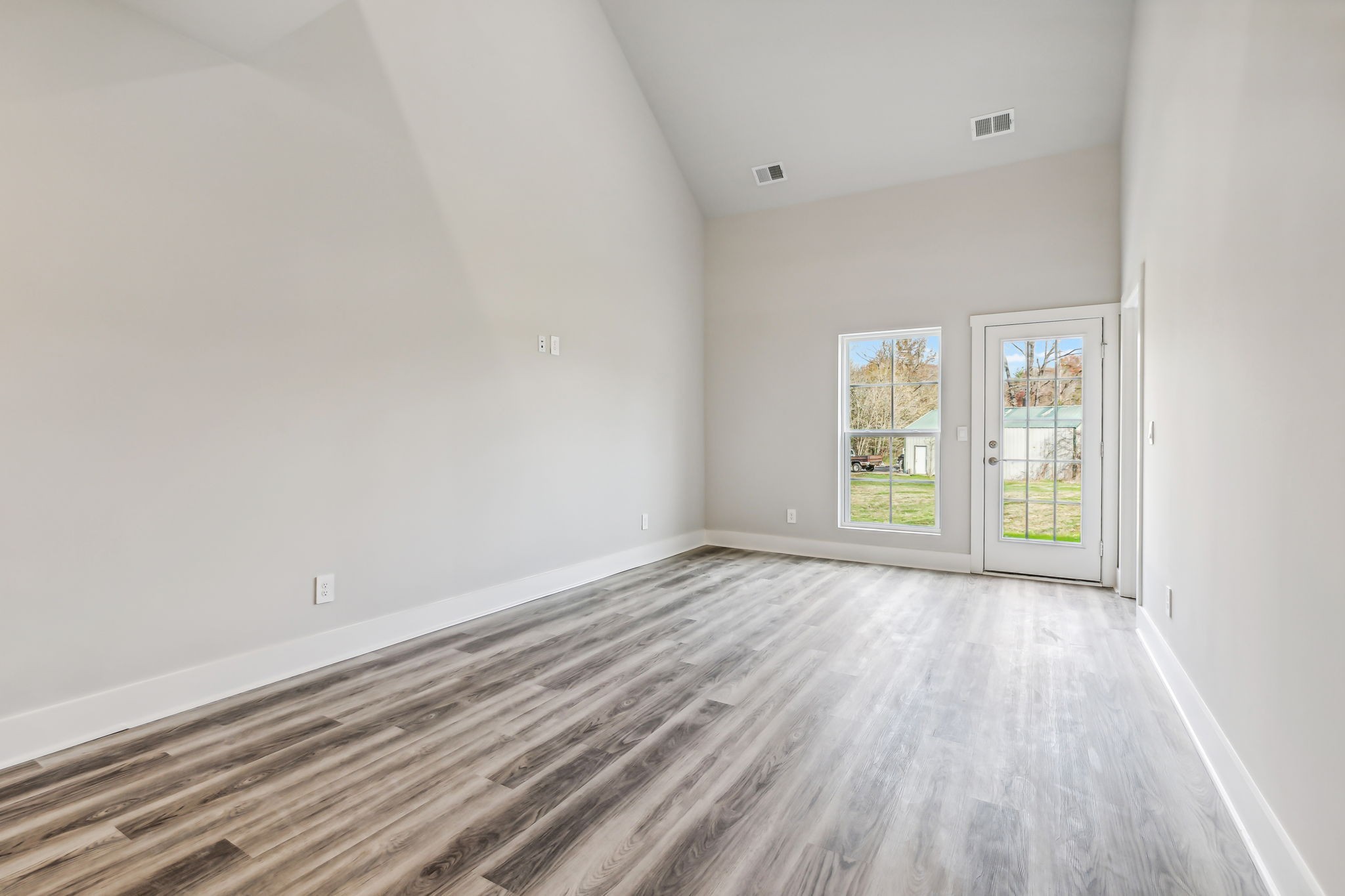 539 Tulip Springs Road Hermitage, TN 37076 - Photo 18 of 69 a view of an empty room with wooden floor and a window