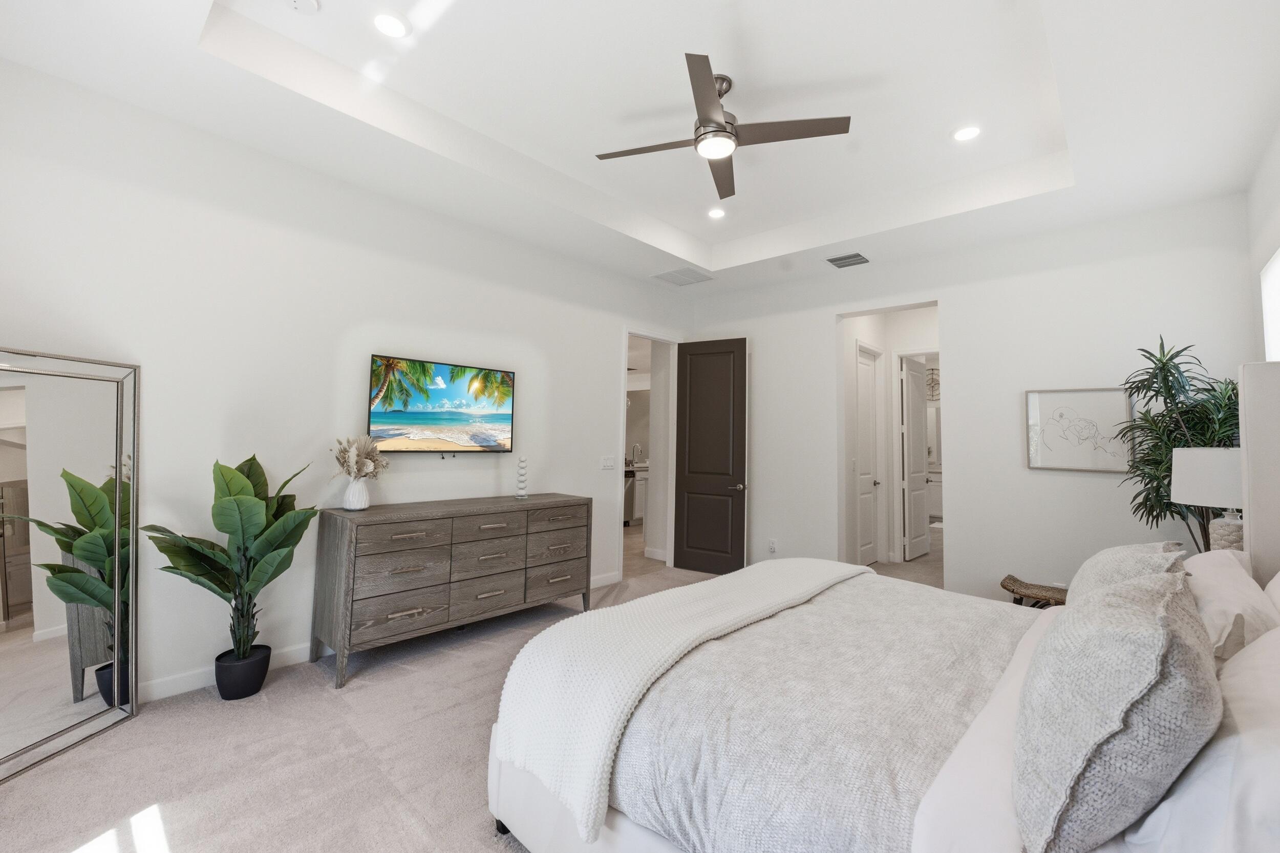 19230 Rolling Acres Road Loxahatchee, FL 33470 - Photo 13 of 58 a bedroom with a bed and a potted plant