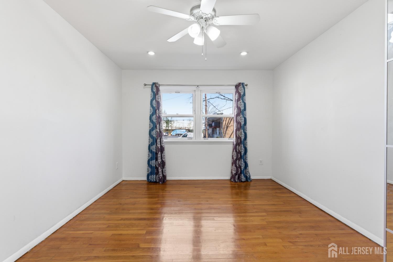 161 Evergreen Road, Unit 2A Edison, NJ 08837 - Photo 14 of 15 a view of empty room with wooden floor and fan