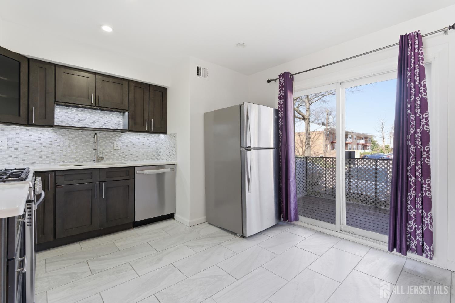 161 Evergreen Road, Unit 2A Edison, NJ 08837 - Photo 9 of 15 a kitchen with stainless steel appliances granite countertop a refrigerator and a sink