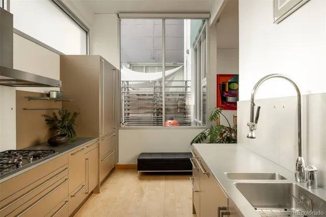 a view of a livingroom with furniture and floor to ceiling window
