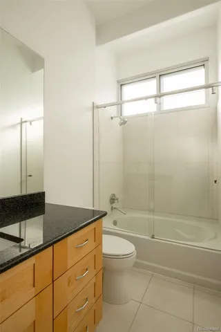 a view of a balcony with chairs and wooden floor