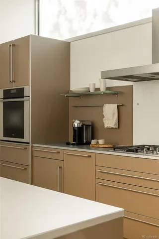 a kitchen with stainless steel appliances granite countertop a sink and a refrigerator