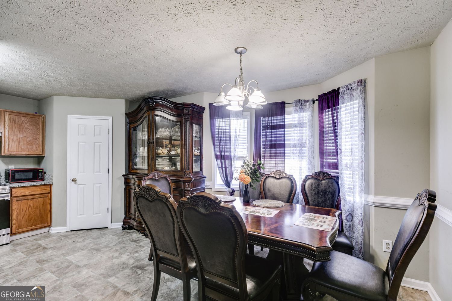 674 Fairview Drive Dallas, GA 30157 - Photo 12 of 24 a view of a dining room with furniture and chandelier