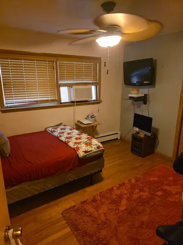 a bedroom with a bed and a television