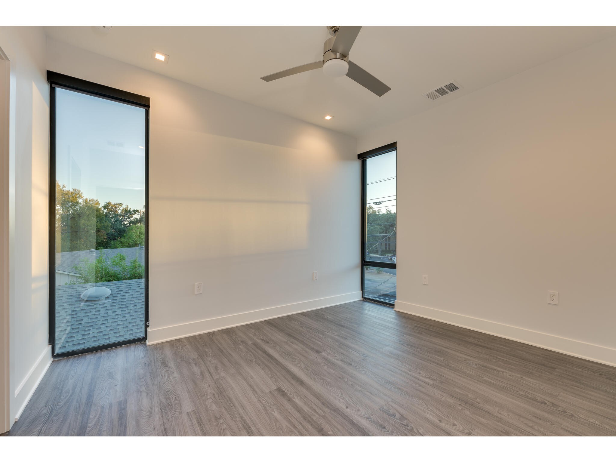 3617 Bull Creek Road Austin, TX 78731 - Photo 7 of 17 a view of an empty room with wooden floor and a window