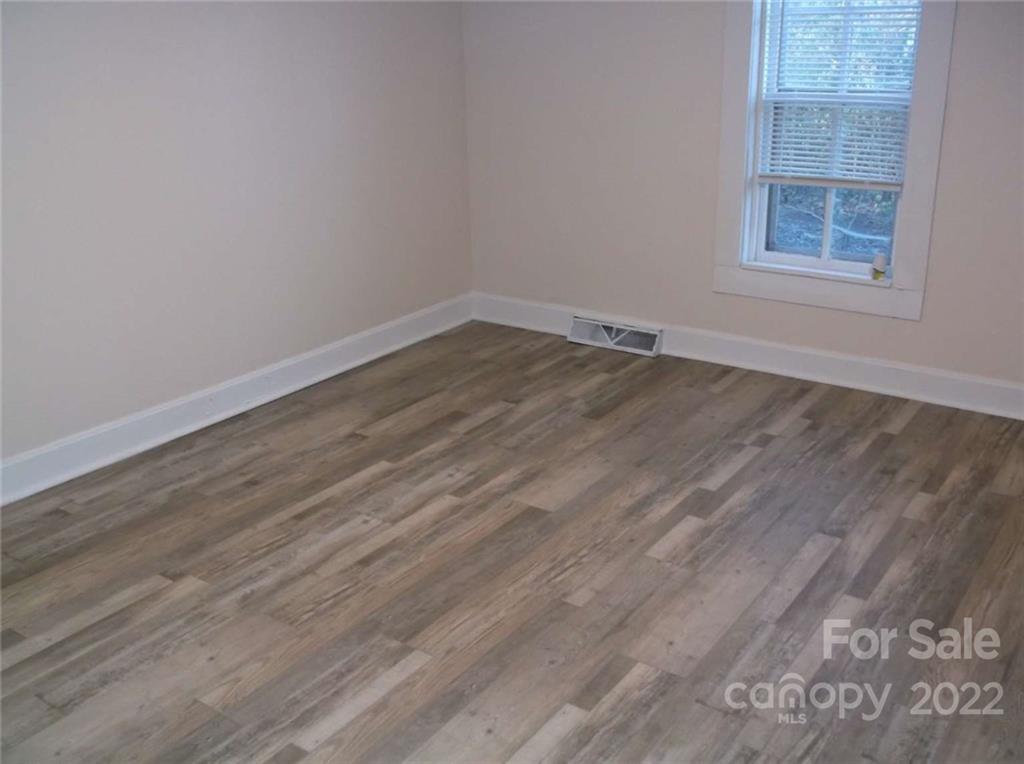 216 Whiteside Road Rutherfordton, NC 28139 - Photo 4 of 18 an empty room with wooden floor and windows