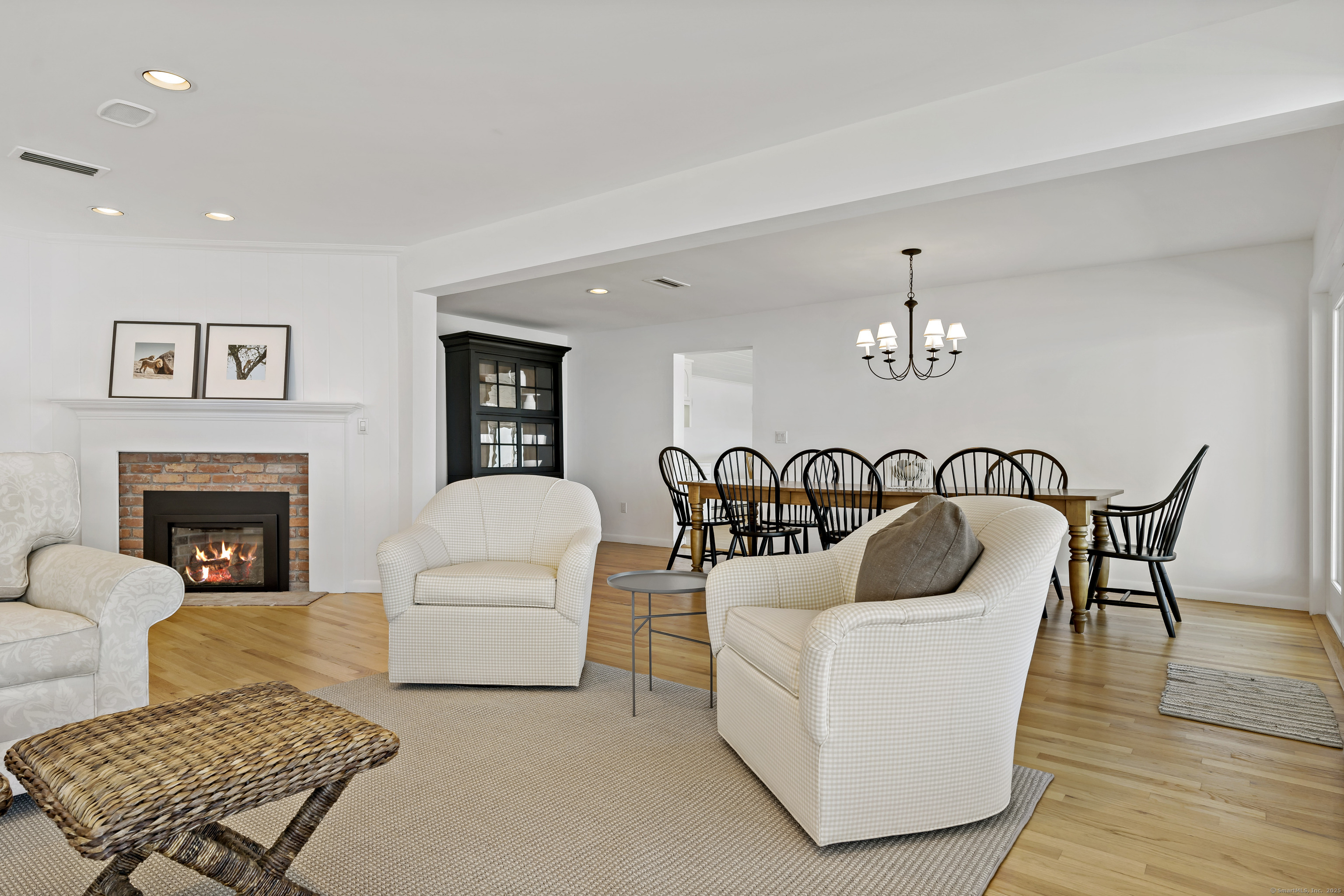 43 Shore Road Clinton, CT 06413 - Photo 11 of 32 a living room with furniture and a fireplace