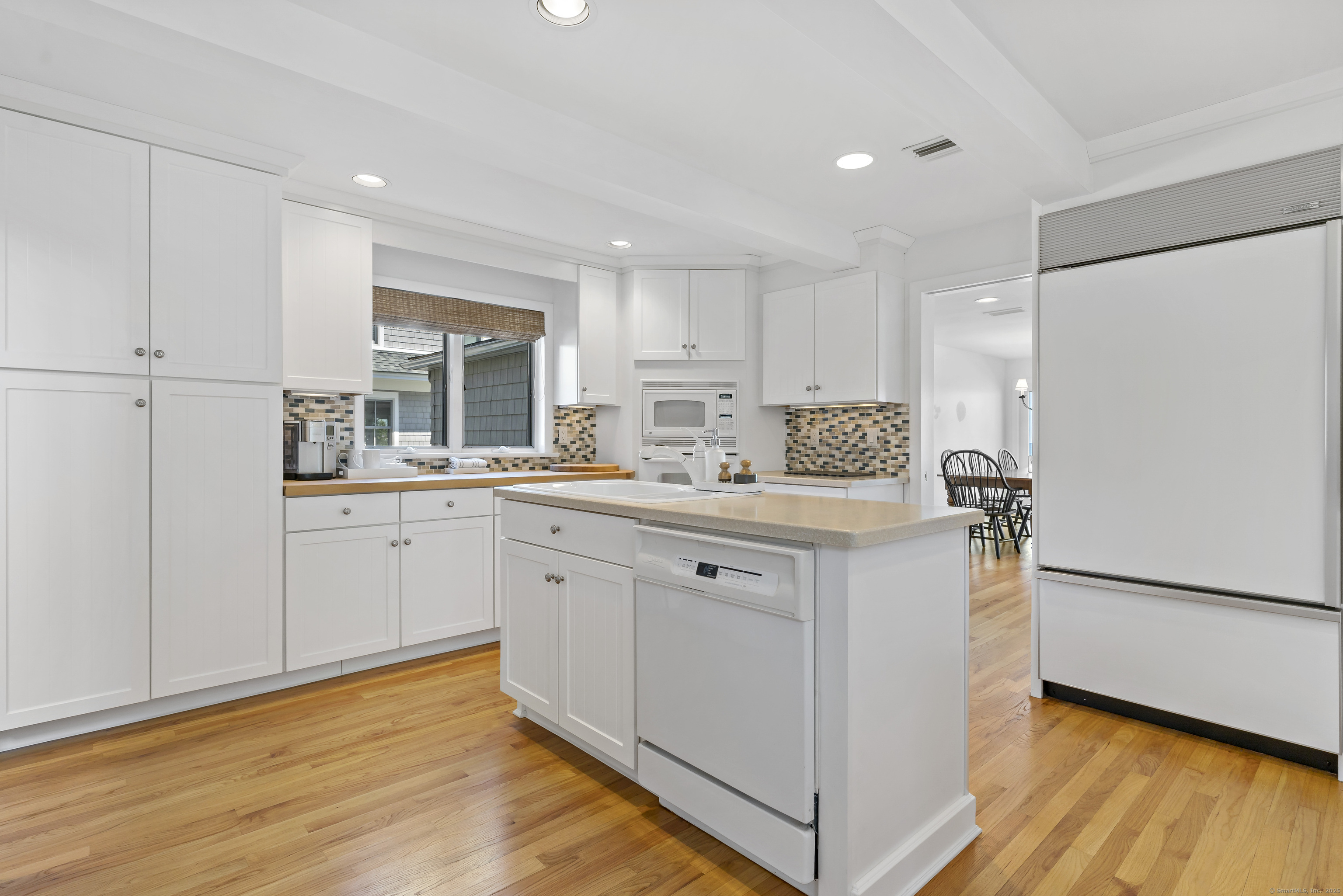 43 Shore Road Clinton, CT 06413 - Photo 17 of 32 a kitchen with granite countertop white cabinets and white appliances