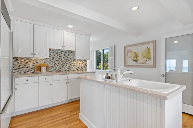 a kitchen with granite countertop a sink and cabinets