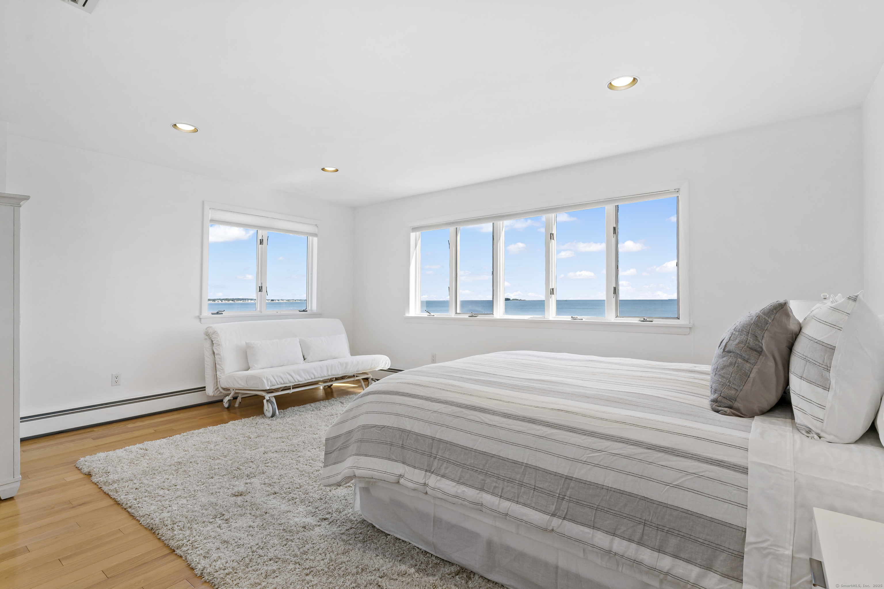 43 Shore Road Clinton, CT 06413 - Photo 19 of 32 a bedroom with a bed and a window