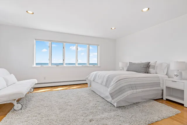 a spacious bedroom with a bed and a couch