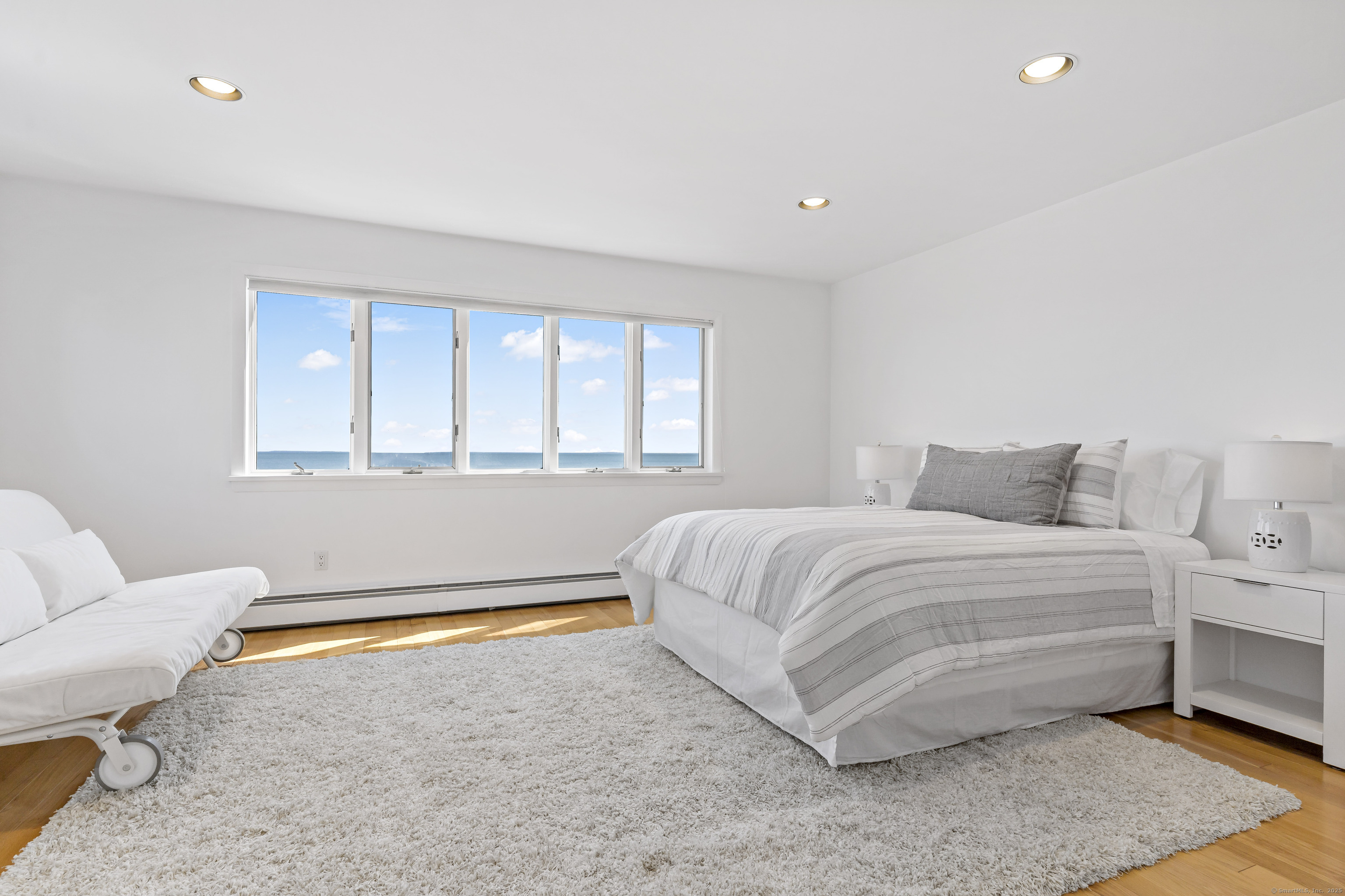 43 Shore Road Clinton, CT 06413 - Photo 20 of 32 a spacious bedroom with a bed and a couch