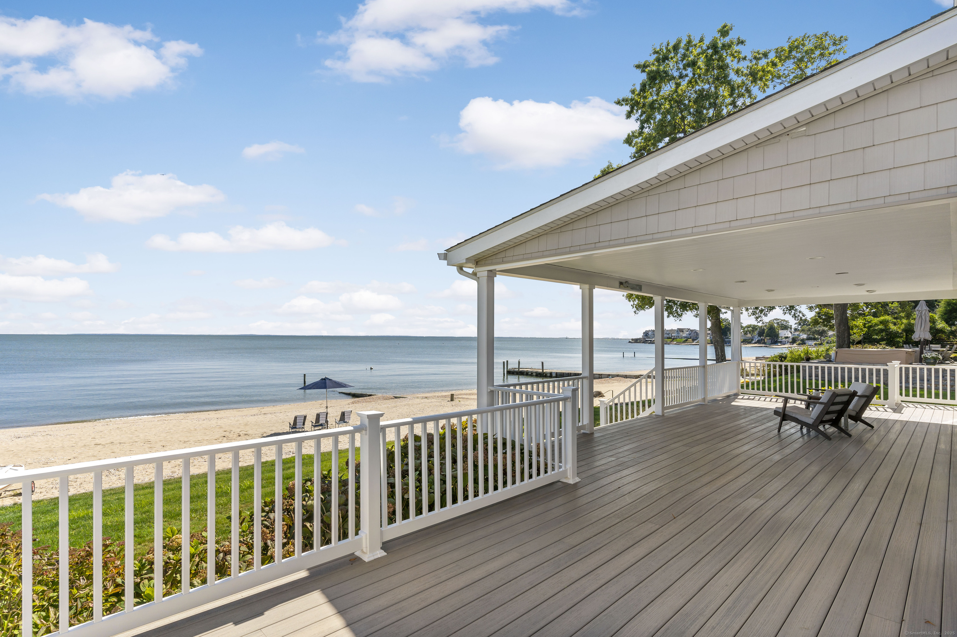 43 Shore Road Clinton, CT 06413 - Photo 29 of 32 a roof deck with table and chairs and wooden floor