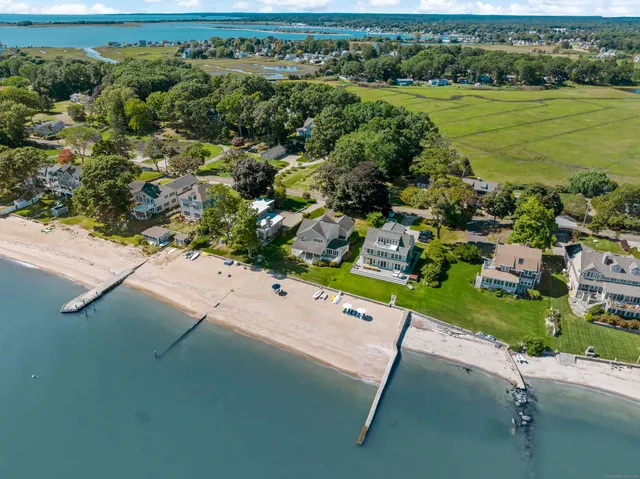 an aerial view of residential houses with outdoor space and river