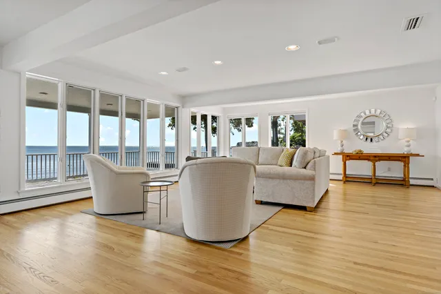 a living room with furniture and large windows