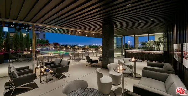 a outdoor living space with furniture and a grill