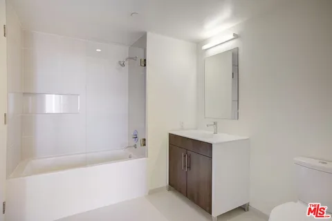a bathroom with a bathtub a shower a sink and a toilet