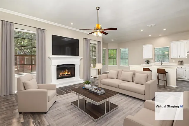 a living room with furniture a flat screen tv and a fireplace