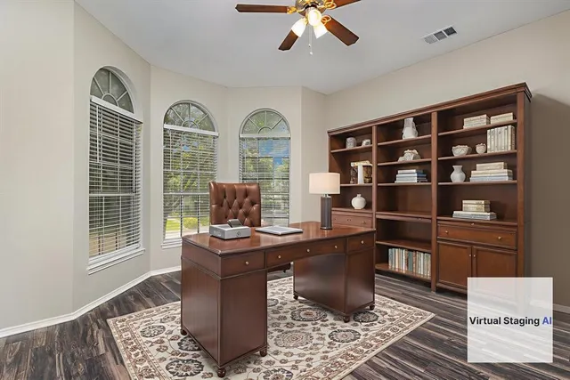 a view of a workspace with furniture and a window