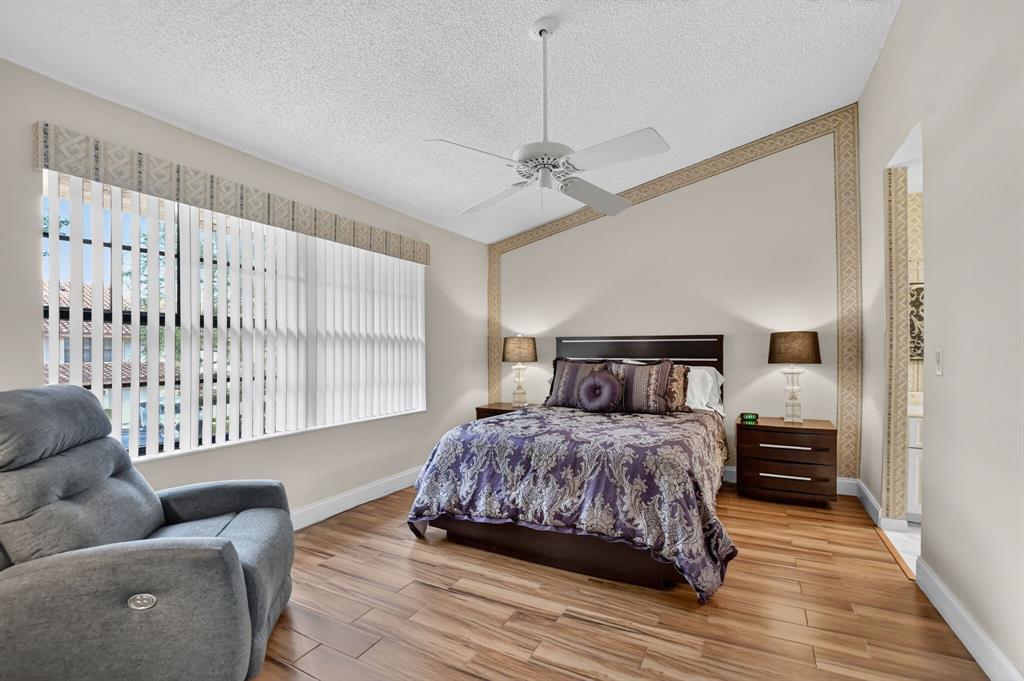 7873 La Mirada Drive, Unit 7873 Boca Raton, FL 33433 - Photo 20 of 40 a bedroom with a bed couch and a window